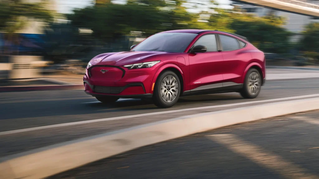 2025 Ford Mustang Mach-E® electric SUV driving through an urban road.