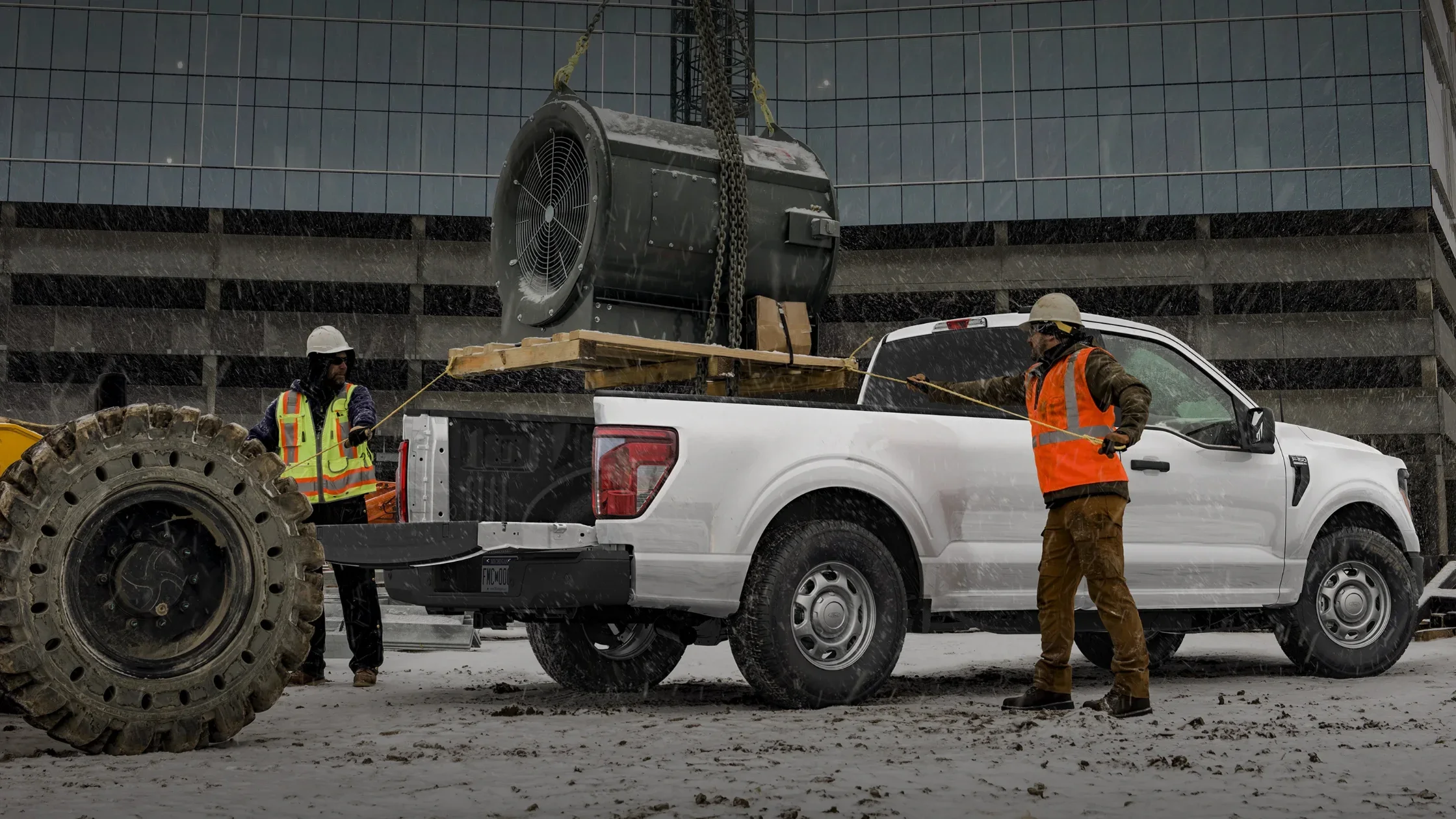 2025 Ford F-150® work truck loaded with industrial equipment at snowy job site