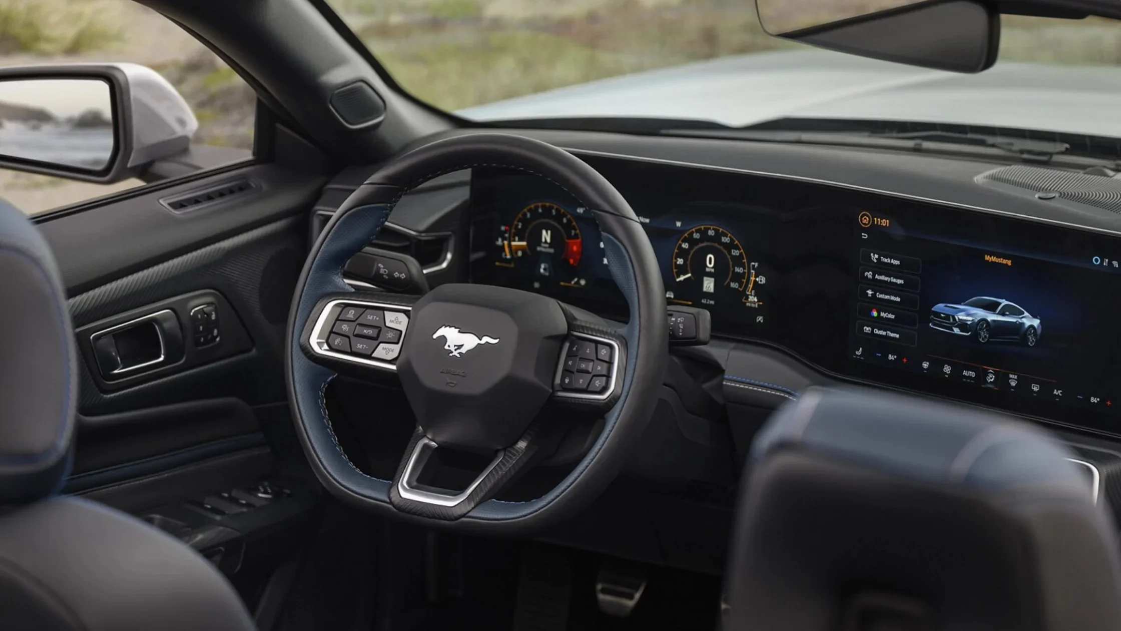 2025 Mustang® interior with digital cockpit, steering wheel, and large infotainment screen.