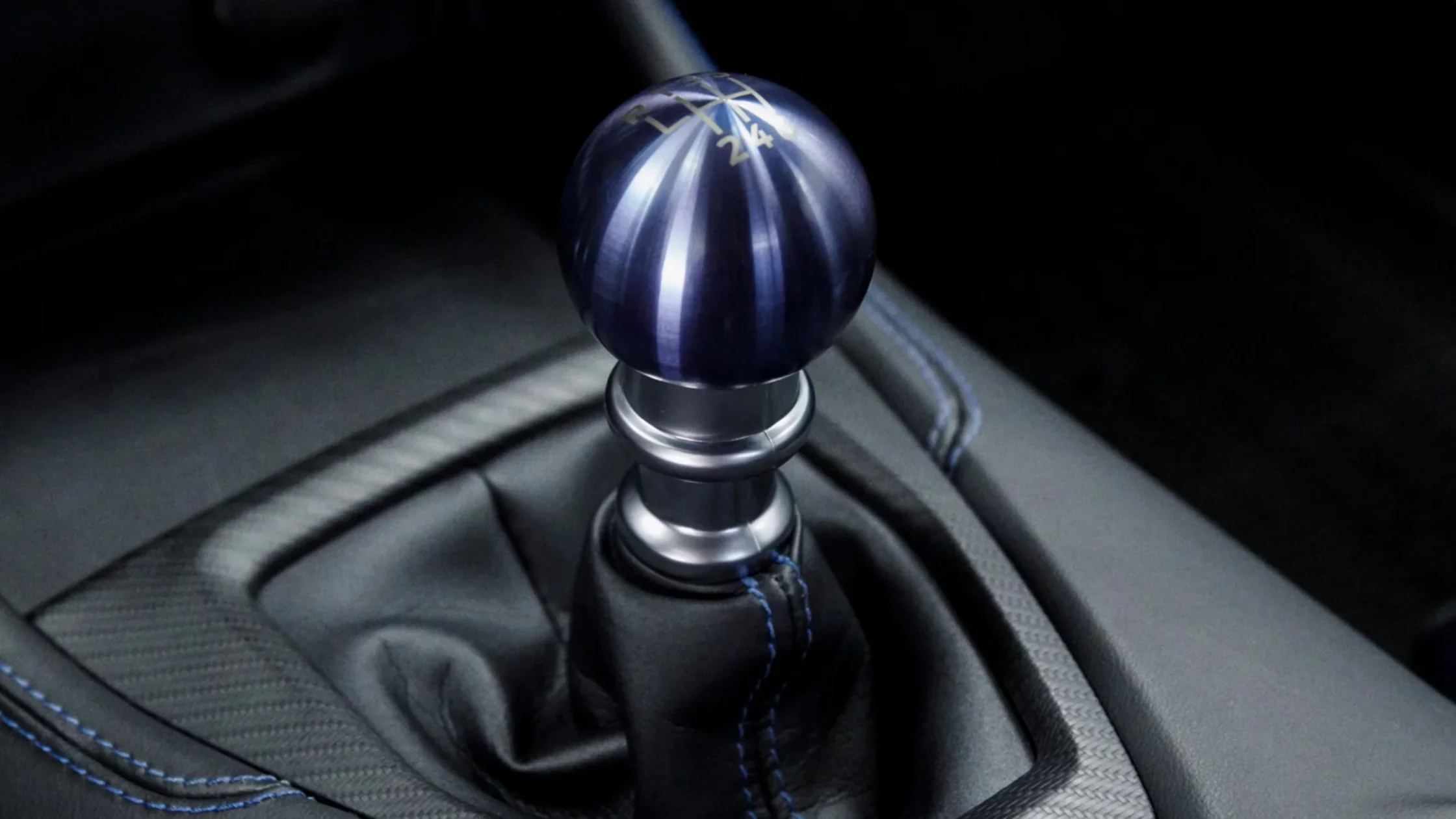 Close-up of 2025 Mustang® manual gear shifter with metallic blue shift knob.
