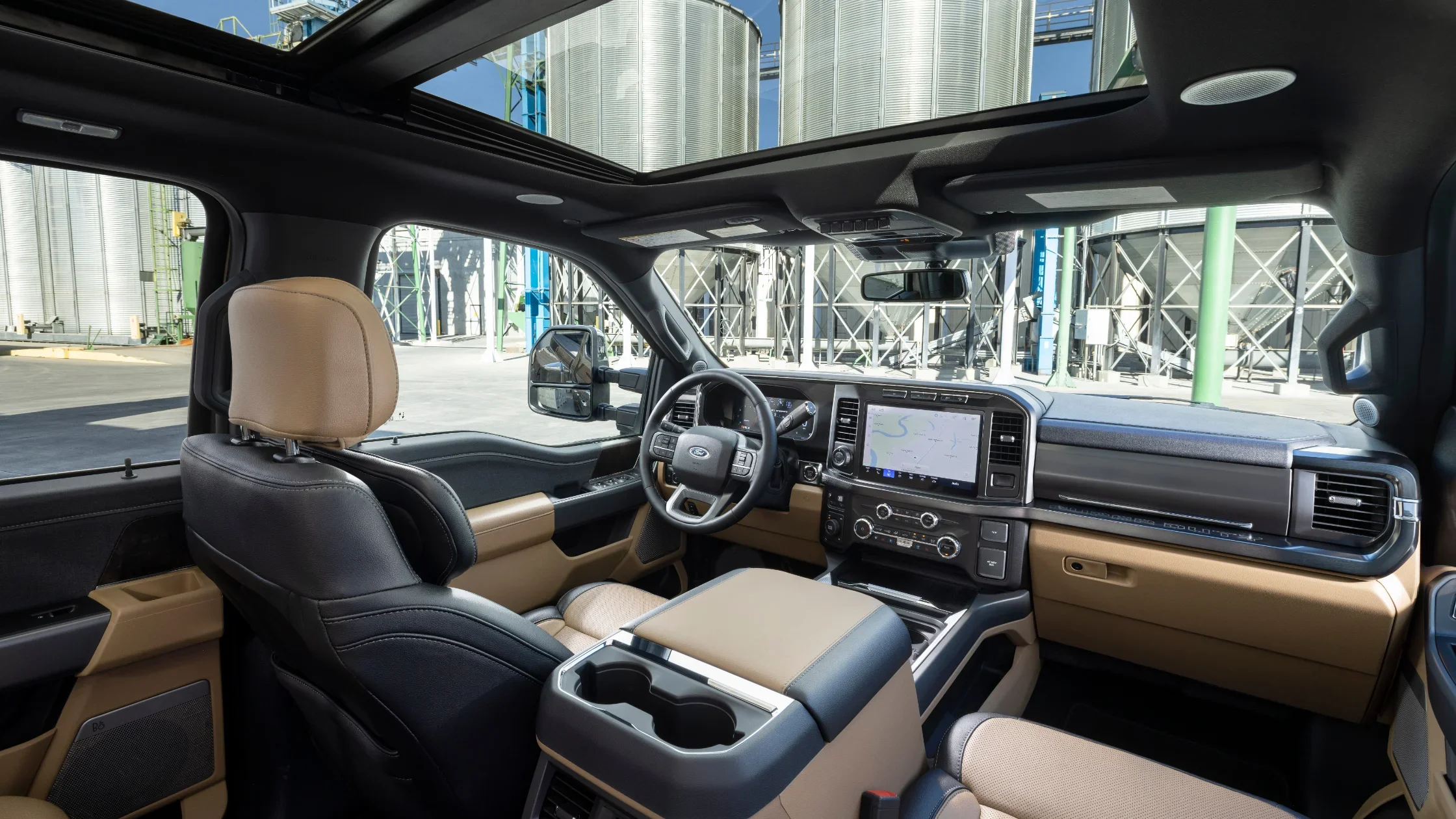 Interior cabin view of the 2025 Ford Super Duty F-350 featuring a panoramic sunroof and dual-tone dashboard