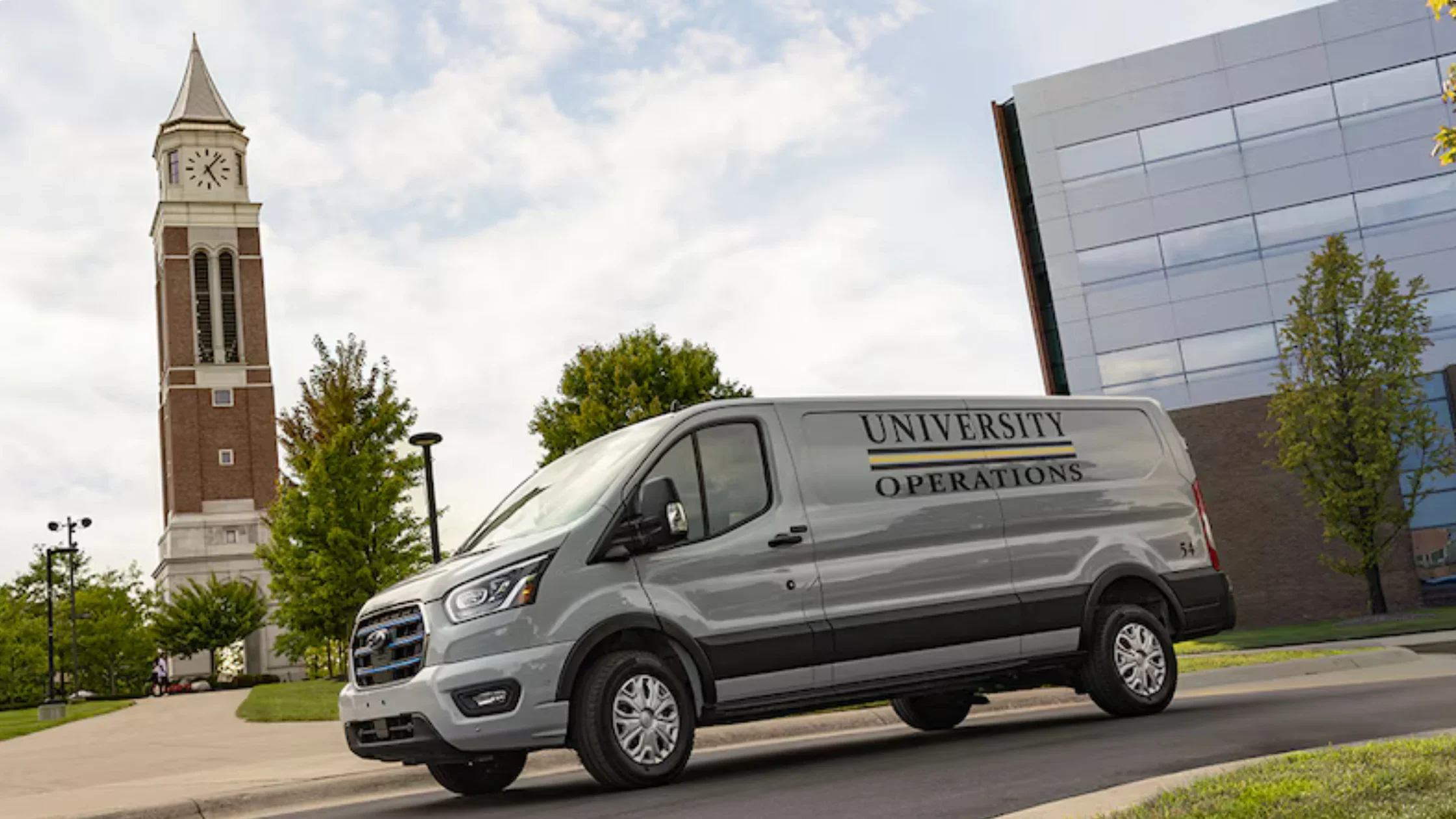 2025 Ford E-Transit™ parked near city buildings showcasing its spacious cargo design and utility focus