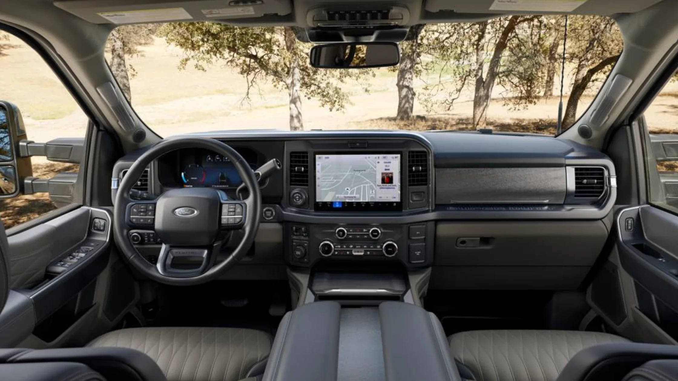 Interior of the 2025 Ford Super Duty® F-350® featuring a touchscreen infotainment display with navigation view.